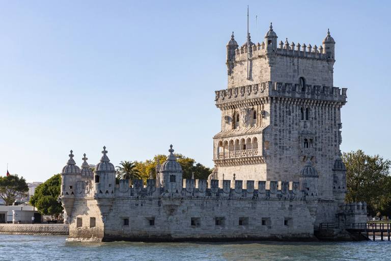 Belém Tower standing in the Tagus, with its bastion, corner turrets and pale limestone walls in clear sunlight.